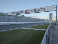 there is a big sign on the side of the track at the race track saying tissot