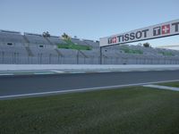 there is a big sign on the side of the track at the race track saying tissot