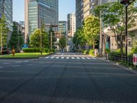 an empty road with a street sign at the curb in front of an office building