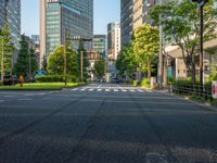 an empty road with a street sign at the curb in front of an office building