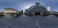 an artistic view of a courtyard in an modern city setting with buildings on either side