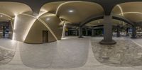 a fisheye lens panoramic of a building with arched arches and columns and decorative glass walls