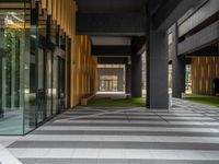 a walkway leading up to a wooden wall next to a cement area with floor tiles