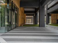 a walkway leading up to a wooden wall next to a cement area with floor tiles