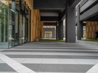 a walkway leading up to a wooden wall next to a cement area with floor tiles