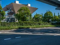 the city of richmond has long white arrows running down it's side and a pedestrian crossing over an expressway