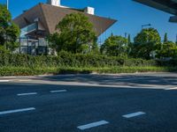 the city of richmond has long white arrows running down it's side and a pedestrian crossing over an expressway