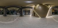 the interior of a building looking into a mirror showing the architecture in different stages of its work