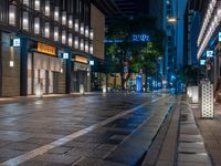 a large brick sidewalk with a store front at night time and a sign that says