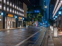 a large brick sidewalk with a store front at night time and a sign that says