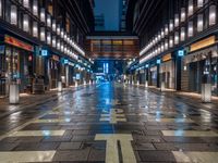 a large brick sidewalk with a store front at night time and a sign that says