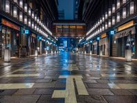 a large brick sidewalk with a store front at night time and a sign that says