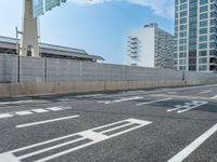 an empty street with building in the background, and road markers for walking directions on it