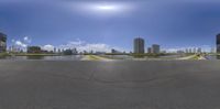 a panoramic view of buildings in the city from a ramp in the middle of the street