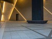 a hallway with columns on the wall that have led lights coming out of them and a door is behind the wall