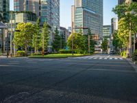 an empty road with a street sign at the curb in front of an office building