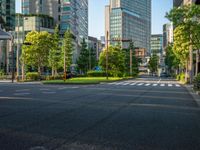 an empty road with a street sign at the curb in front of an office building