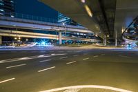 the view of a long exposure of a freeway bridge at night with light streaking down