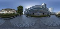 a fish eye view of a building and lawn area with a bench on the side