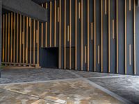 a walkway leading up to a wooden wall next to a cement area with floor tiles