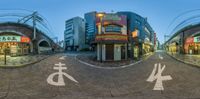 a 360 view of a city street intersection in japan with white signs and numbers on the road