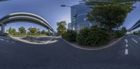 a fish eye photo of a street scene with cars on it and tall buildings in the distance