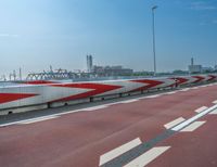 the highway has two lanes and red and white stripes on it for transportation safety zones