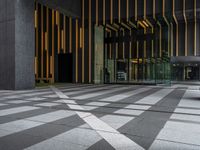 a walkway leading up to a wooden wall next to a cement area with floor tiles