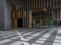 a walkway leading up to a wooden wall next to a cement area with floor tiles