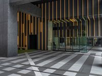 a walkway leading up to a wooden wall next to a cement area with floor tiles