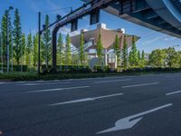 the city of richmond has long white arrows running down it's side and a pedestrian crossing over an expressway