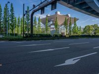 the city of richmond has long white arrows running down it's side and a pedestrian crossing over an expressway