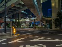 an image of outside of the night time building with the lights turned on and the streets empty