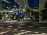 an image of outside of the night time building with the lights turned on and the streets empty