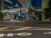 an image of outside of the night time building with the lights turned on and the streets empty