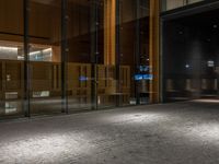 an open door at the lobby of a modern building with glass doors on either side