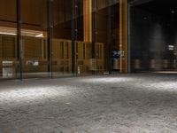 an open door at the lobby of a modern building with glass doors on either side