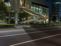 an image of outside of the night time building with the lights turned on and the streets empty