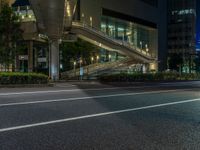 an image of outside of the night time building with the lights turned on and the streets empty