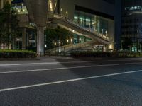 an image of outside of the night time building with the lights turned on and the streets empty