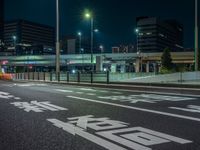 an image of outside of the night time building with the lights turned on and the streets empty