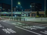 an image of outside of the night time building with the lights turned on and the streets empty