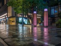 a large brick sidewalk with a store front at night time and a sign that says