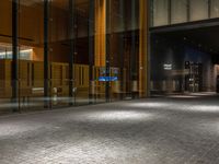 an open door at the lobby of a modern building with glass doors on either side