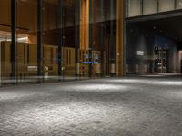 an open door at the lobby of a modern building with glass doors on either side