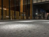 an open door at the lobby of a modern building with glass doors on either side