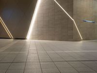 a hallway with columns on the wall that have led lights coming out of them and a door is behind the wall