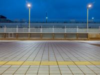 people standing on a subway platform with many buildings in the background at night light in tokyo