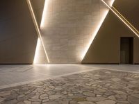 a hallway with columns on the wall that have led lights coming out of them and a door is behind the wall