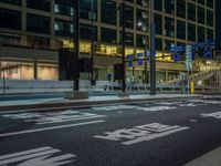 an image of outside of the night time building with the lights turned on and the streets empty